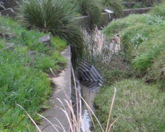 large piece of bent corrugated iron in the waterway