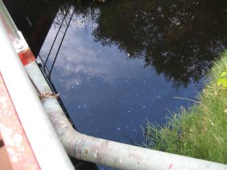 many patches of oil (?) on the surface  -near the bridge