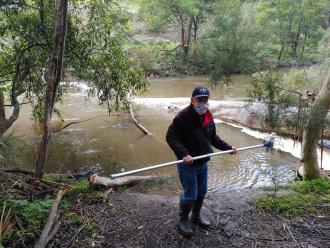 Jim Stranger collecting water sample