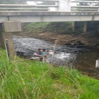 Aiden collecting water sample 