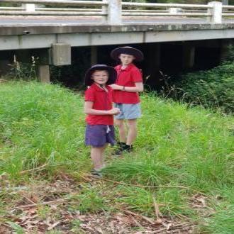 Aiden & Dexter standing amongst weeds at river