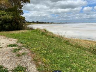 Near shore shallow water,sandy areas;more water middle distance