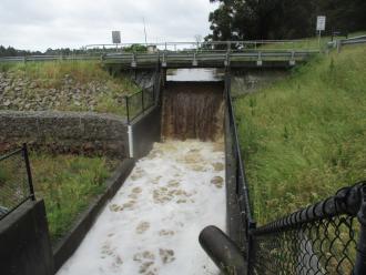 water pouring from catch drain after heavy rains