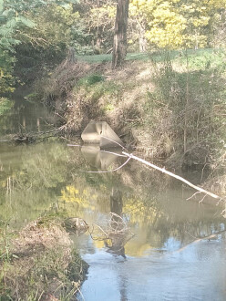 Detached from storm water drain. Bank collapsing behind it.