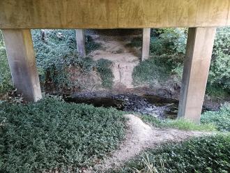 View eastwards under bridge (upstream to right, downstream to left)