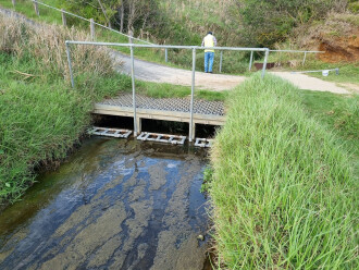 Water drains via the overflow channel into the bay.