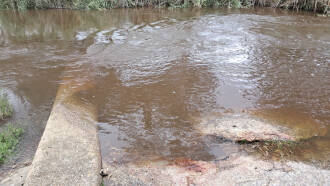 Water sample is usually taken from mid-stream on the concrete pier but that was under water this month.